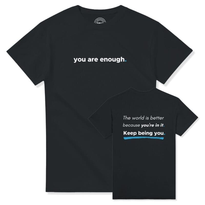 Front and back view of the classic black "You Are Enough" streetwear crew neck t-shirt. The front features a clean, minimalist print reading "you are enough." The back panel displays the full quote layout reading: "The world is better because you're in it. Keep being you." underlined by a sharp blue accent brushstroke.