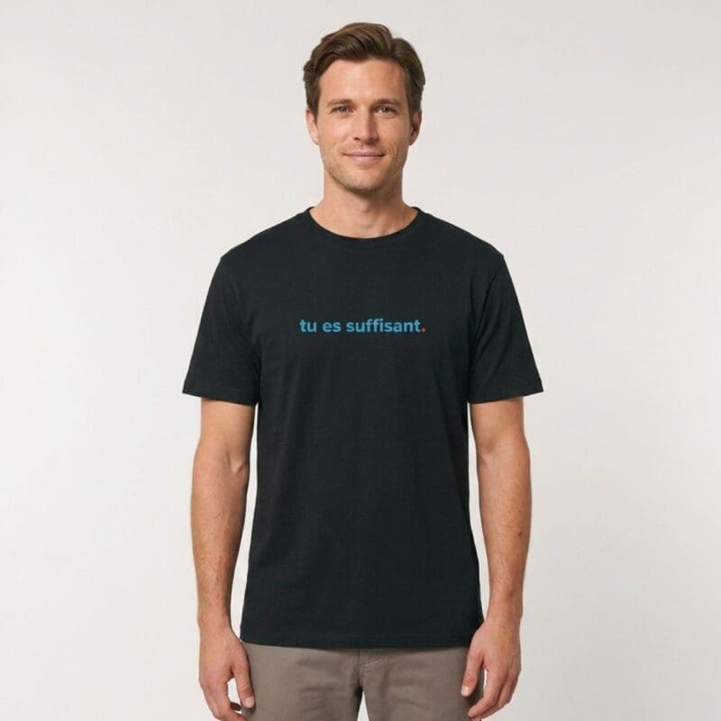 Man wearing black T-shirt with with "tu es suffisant." on the front.
