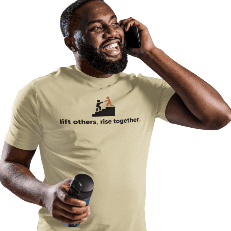 Man smiling, wearing motivational T-shirt, holding dumbbell.