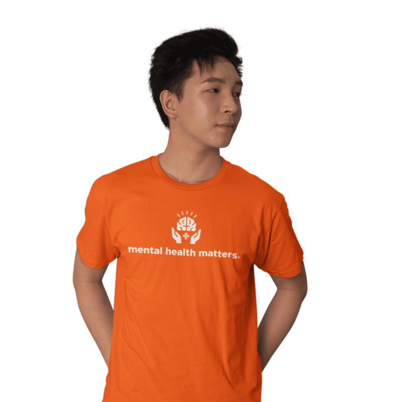 Person wearing orange 'mental health matters' T-shirt.