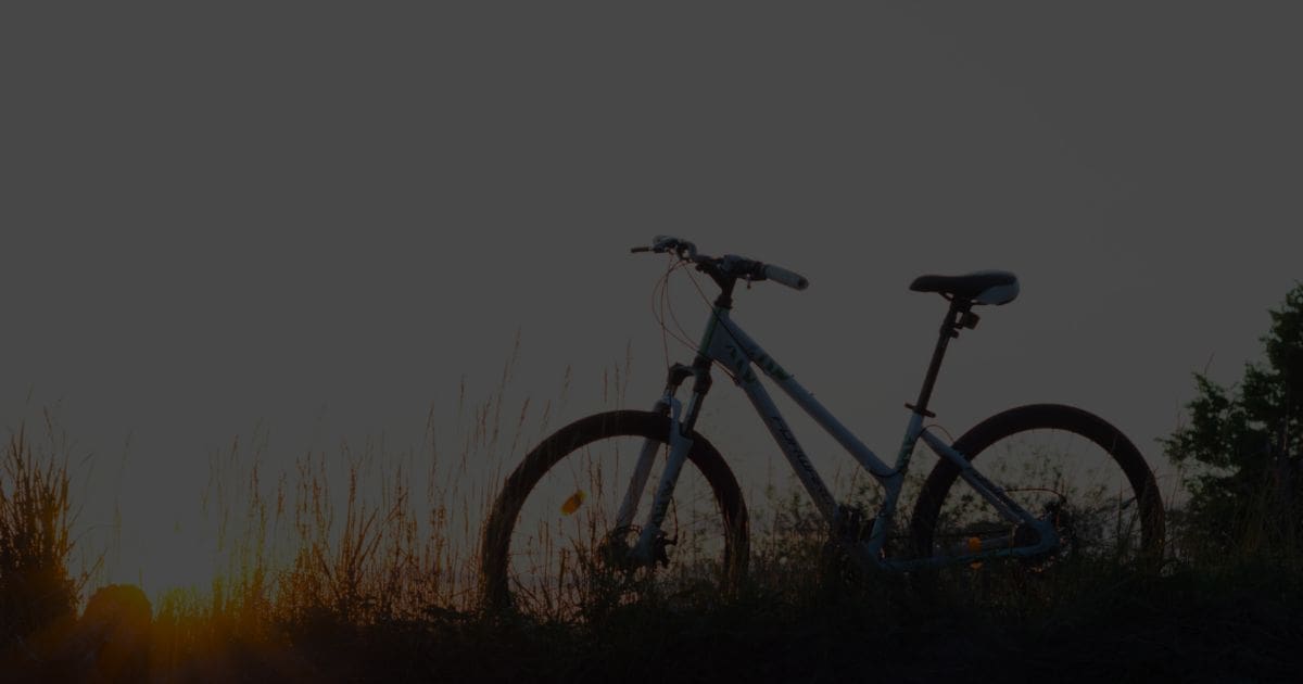 Silhouette of a bicycle at sunset symbolising the Free Bikes 4 Kids project, helping children access bikes for free.
