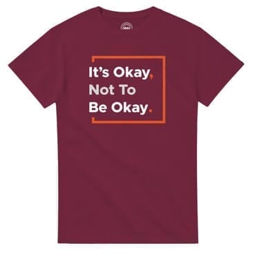 Maroon T-shirt with motivational quote in orange square.