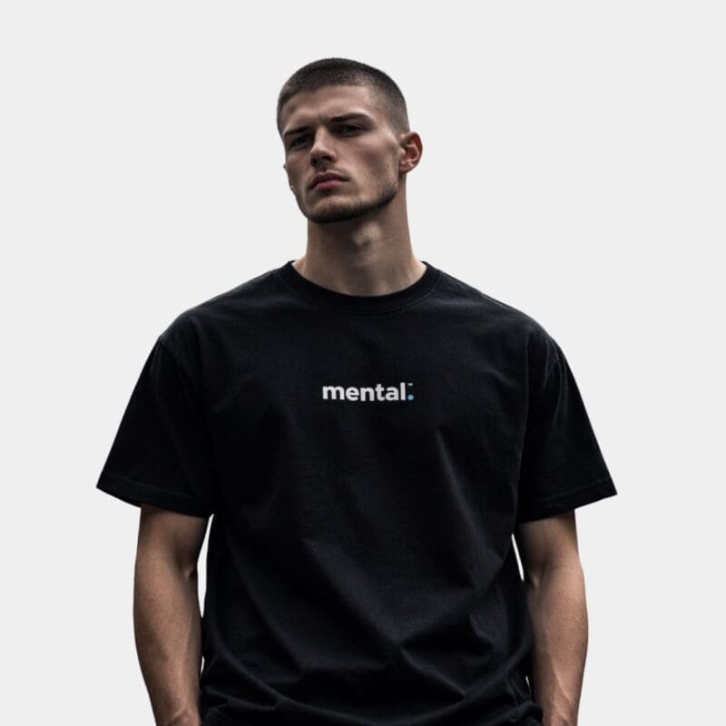 Man wearing 'mental' black t-shirt, white background.