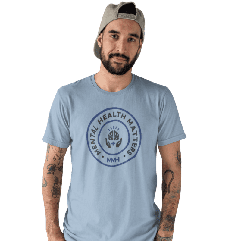 Person wearing Mental Health Matters t-shirt, tattoos visible.