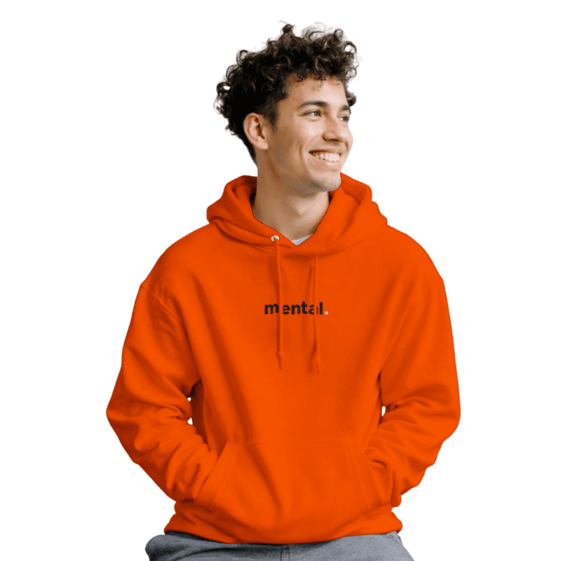 Person in orange hoodie with 'mental' text, smiling.