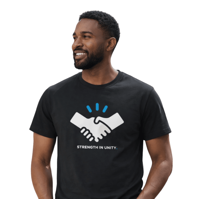 Man wearing 'Strength in Unity' handshake t-shirt.