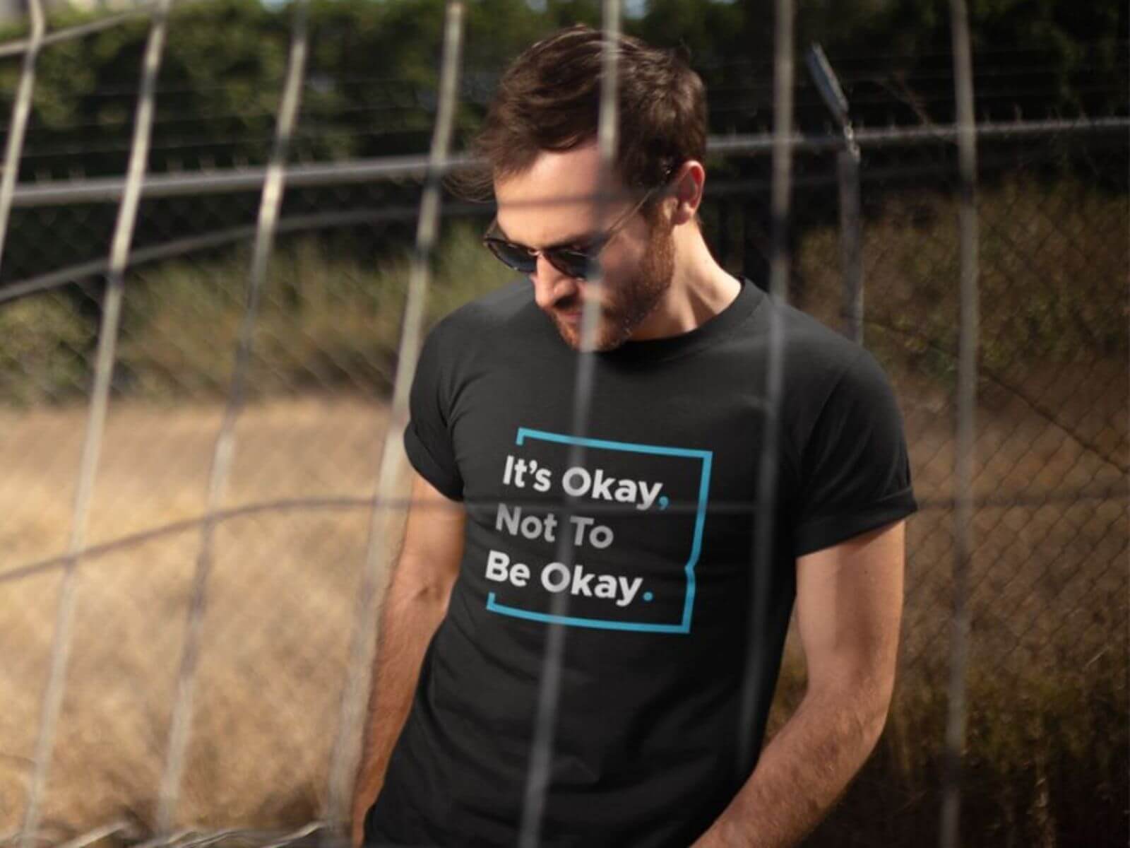 It’s Okay Not To Be Okay Statement T-Shirt – MMH Clothing Man wearing a black It’s Okay Not To Be Okay statement t-shirt, designed to start conversations through purpose-led apparel.