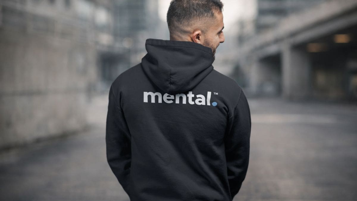 Person wearing mental logo hoodie on street