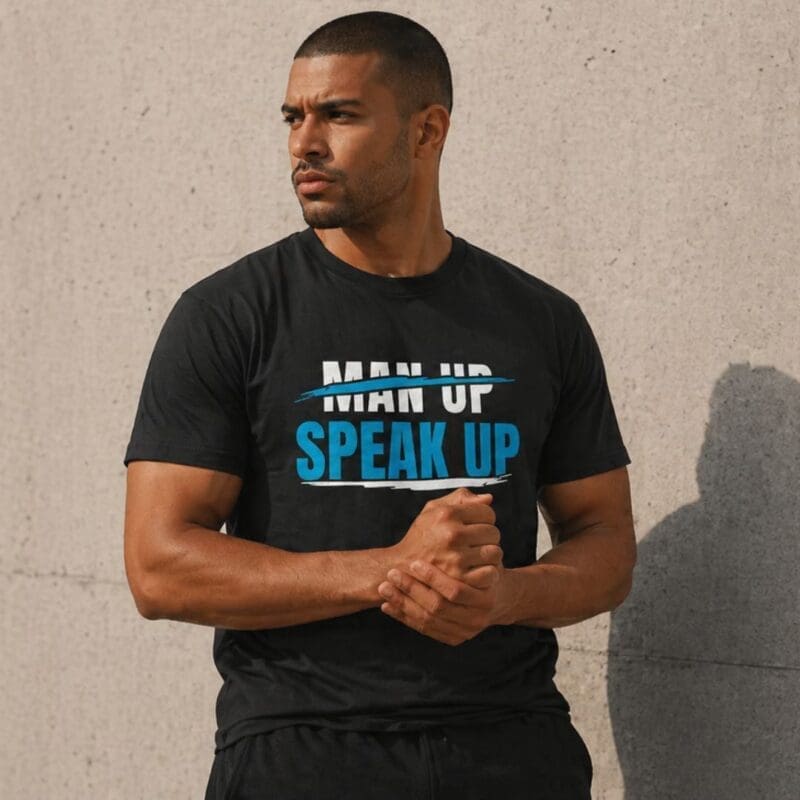 Man wearing 'Man Up Speak Up' slogan T-shirt