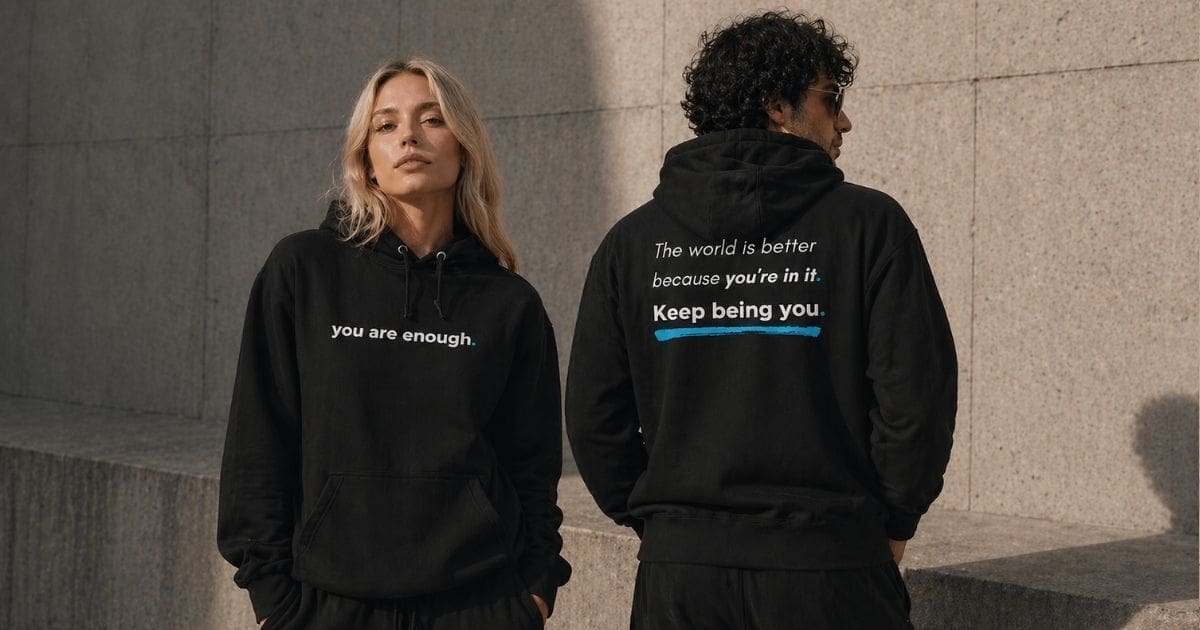 Models wearing black hoodies with positive messages
