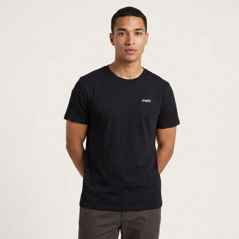 Man wearing black T-shirt with 'meh.' slogan