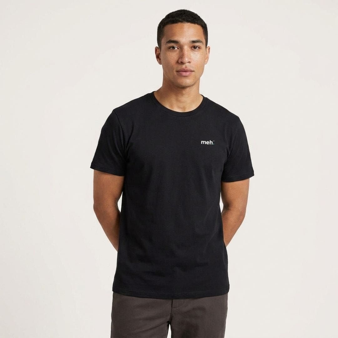 Man wearing black T-shirt with 'meh.' slogan