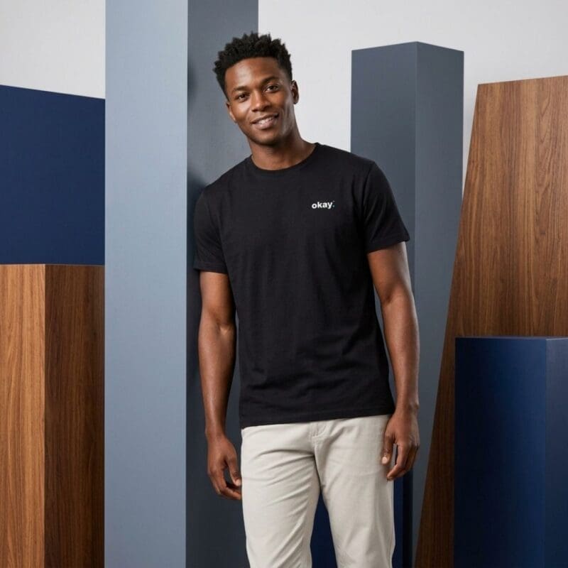 Man wearing black T-shirt against modern backdrop