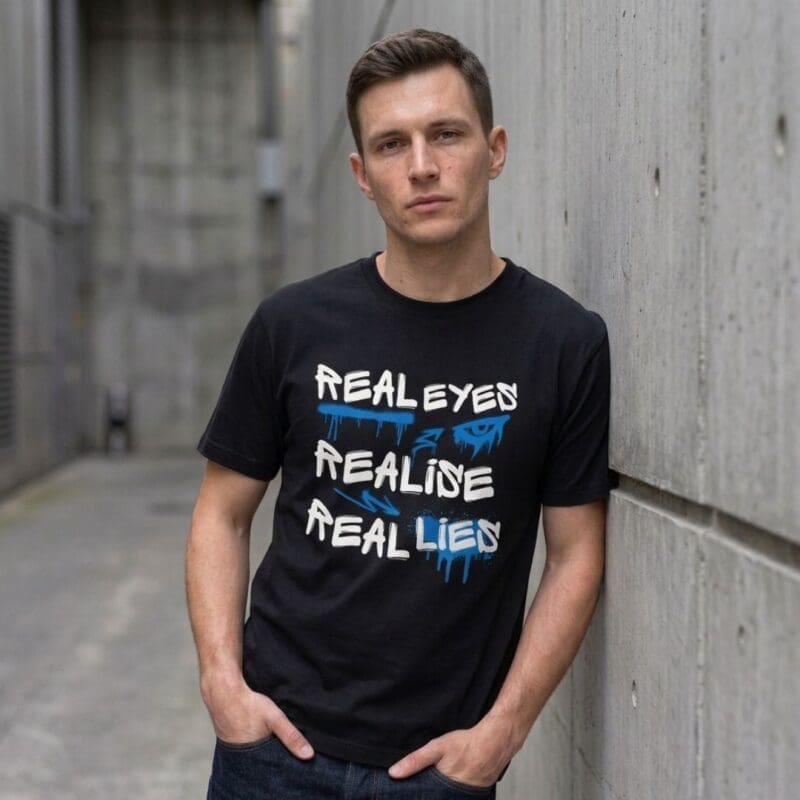 Man wearing 'Real Eyes Realise Real Lies' T-shirt