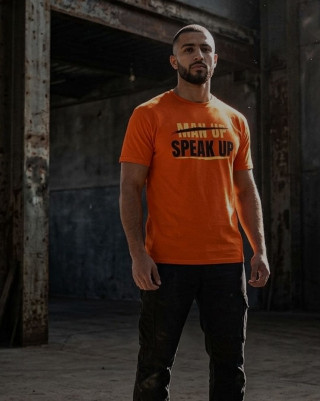 Man wearing orange Speak Up slogan T-shirt