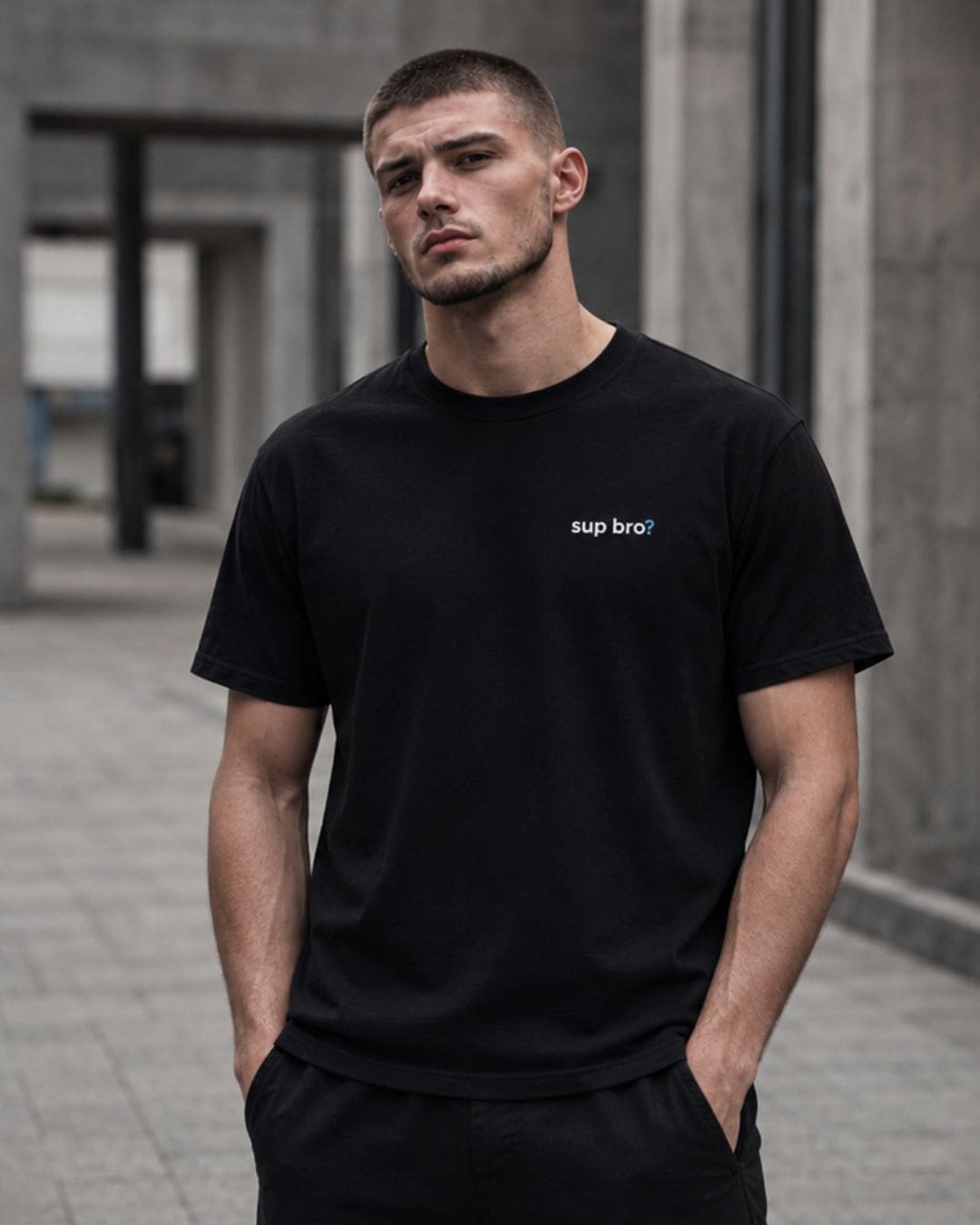 Man wearing black 'sup bro?' T-shirt outdoors