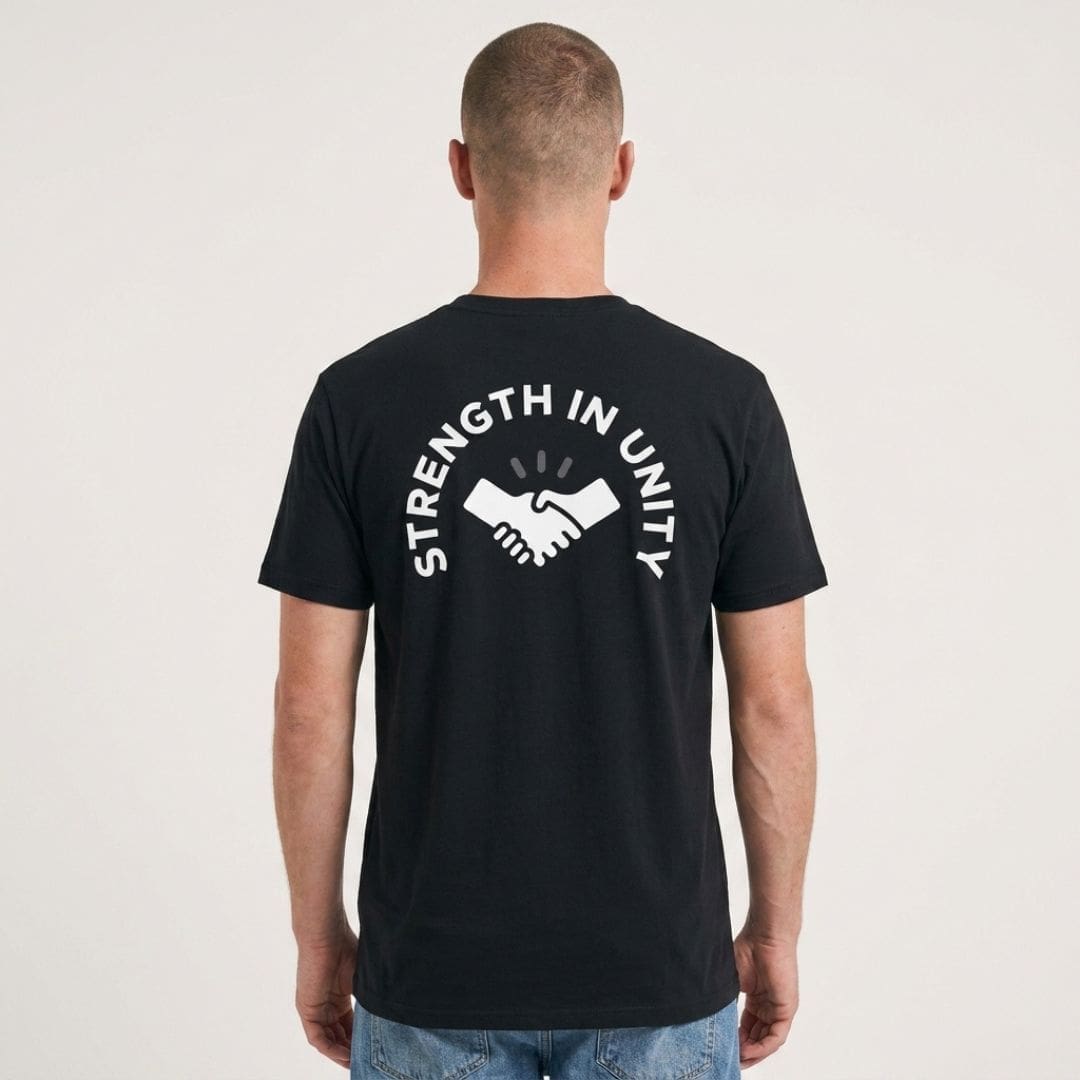 Man wearing black Strength in Unity T-shirt